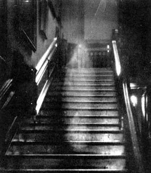 A ghostly white figure on a staircase