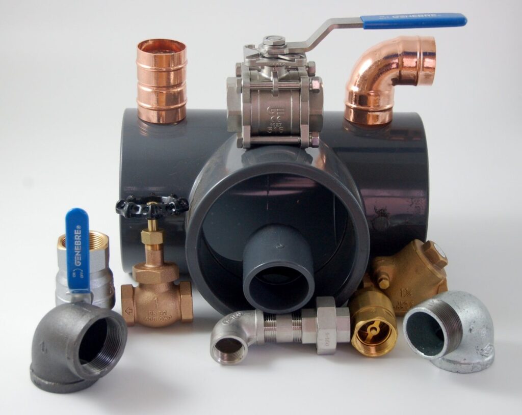 An assortment of valves and pipe fittings covering many sizes and materials.